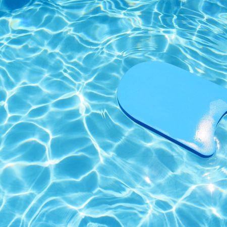 Kick,Board,Floating,In,Swimming,Pool,For,Summer,Vacation,Concept